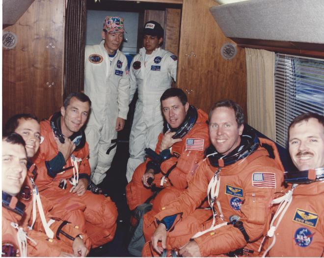 Inside the AstroVan on the way to the launch pad during TCDT, August 1994. L to R: Wisoff, Bursch, Wilcutt, Baker, Jones, and Smith. (NASA)
